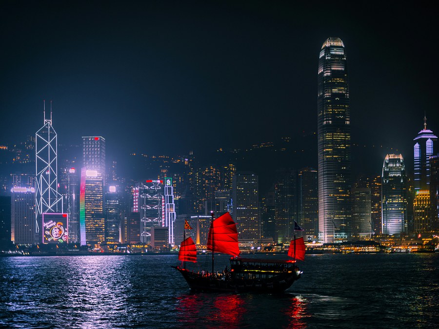 Traditional junk boat crossing Victoria Harbour, Hong Kong