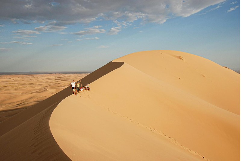 Travellers atop the Khongoryn Els singing sand dunes, Gobi Desert, Mongolia